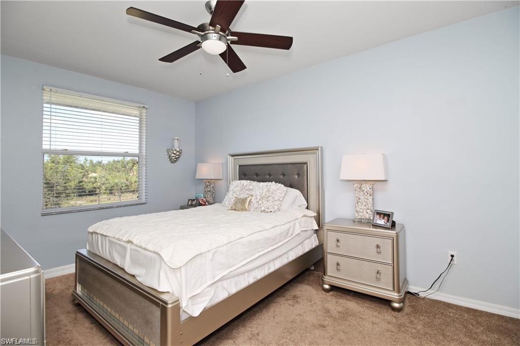 422 Valerie Way, Unit 202 Naples, FL 34104 - Photo 7 of 19 a bedroom with a bed and a window