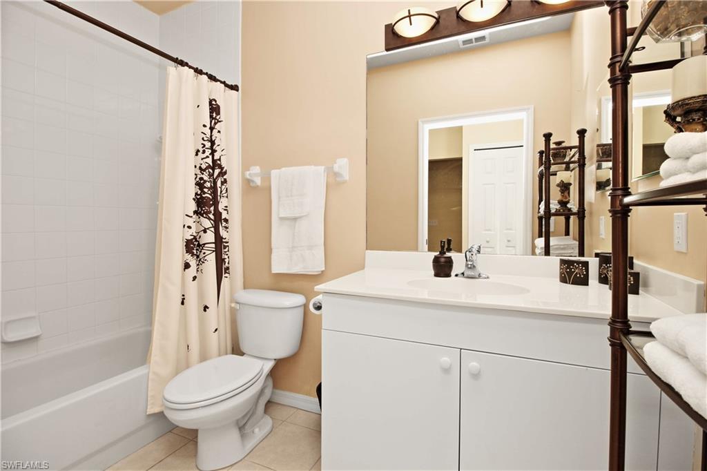422 Valerie Way, Unit 202 Naples, FL 34104 - Photo 10 of 19 a bathroom with a sink a toilet and shower