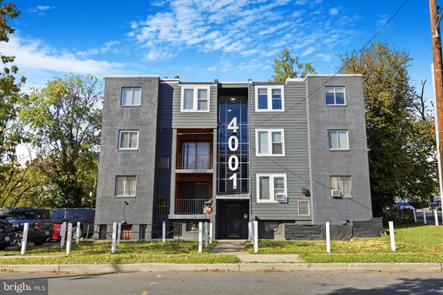 a front view of a building with a yard