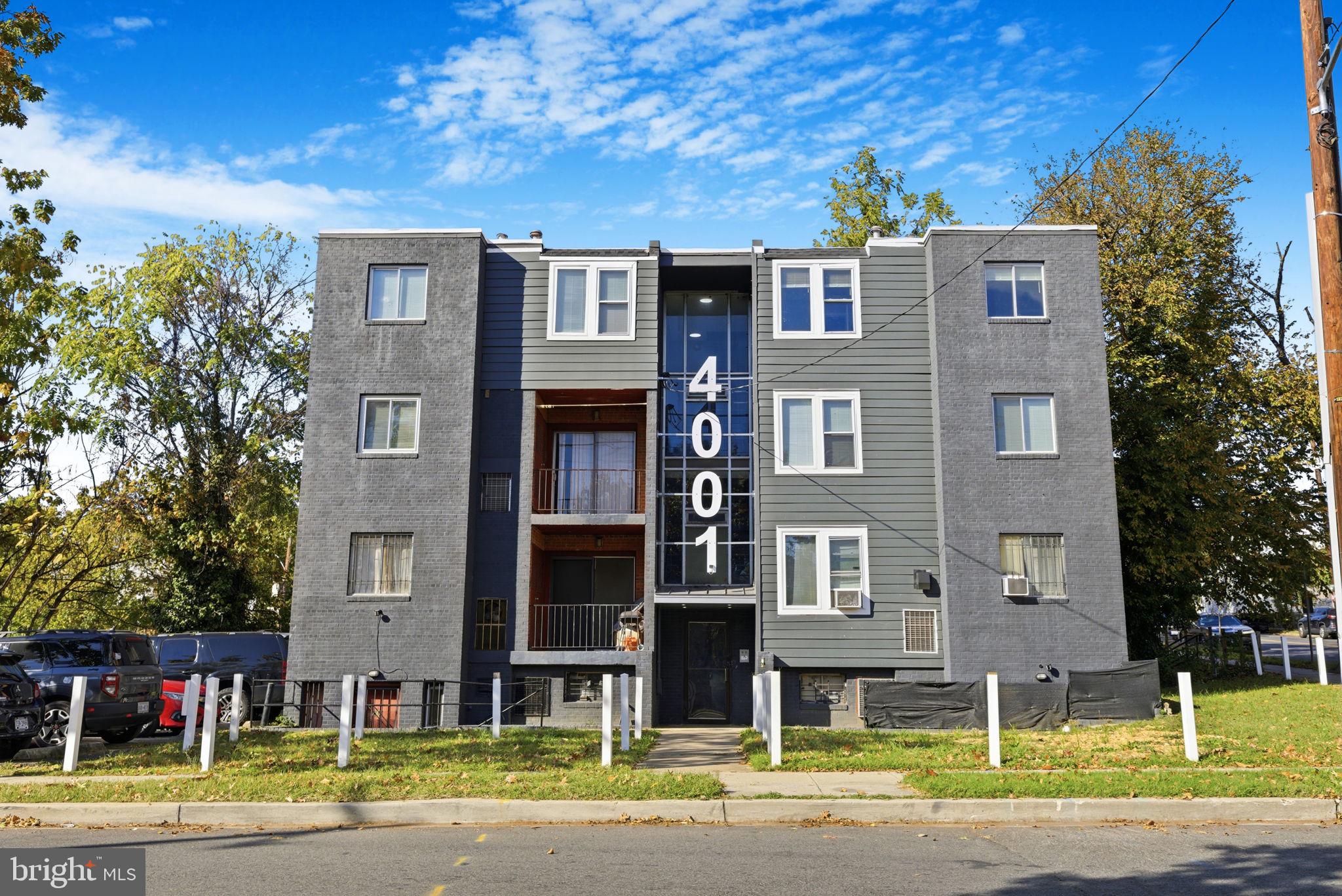 a front view of a building with a yard