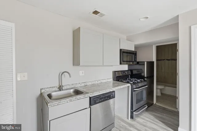 a kitchen with a sink stove and refrigerator