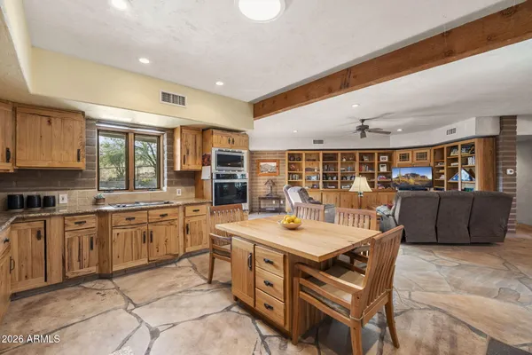 a large kitchen with stainless steel appliances granite countertop a large center island and a stove