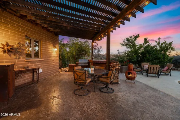 a view of a chairs and table in a patio