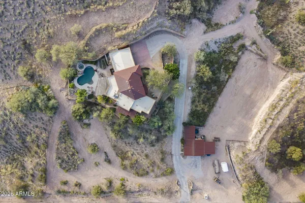an aerial view of a house with a yard and trees