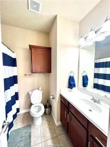 a bathroom with a sink a toilet and a mirror