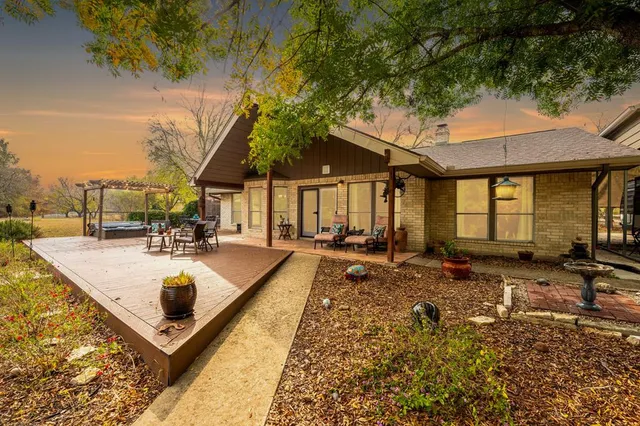 a view of a house with swimming pool and sitting area