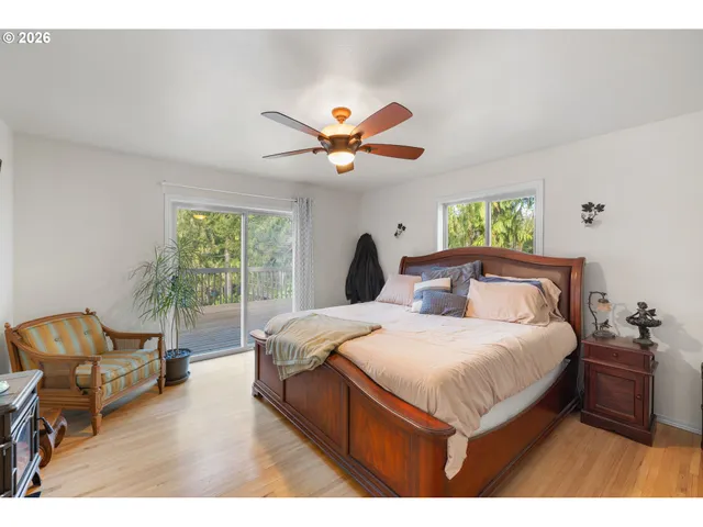 a bedroom with a bed a couch and a potted plant