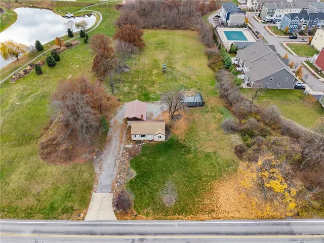 an aerial view of a house with a yard basket ball court and outdoor seating