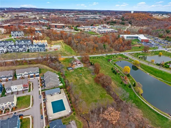 an aerial view of residential houses with outdoor space