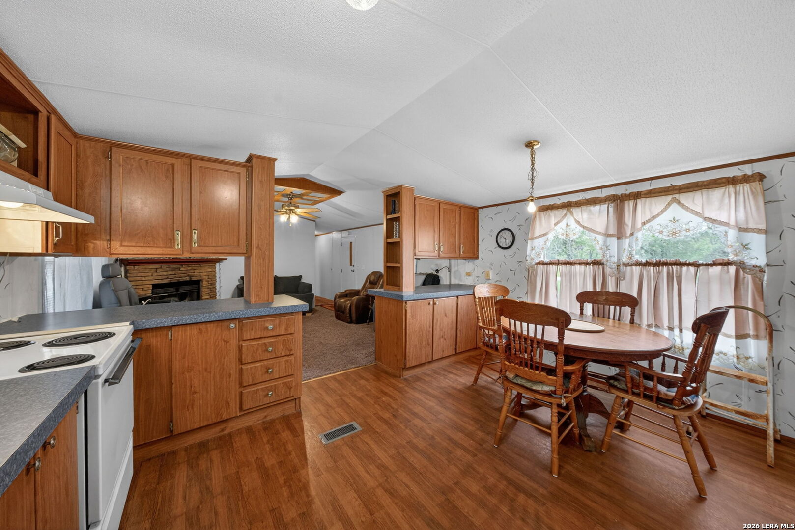 23398 Mathis Road Elmendorf, TX 78112 - Photo 7 of 18 a view of a dining room with furniture window and wooden floor