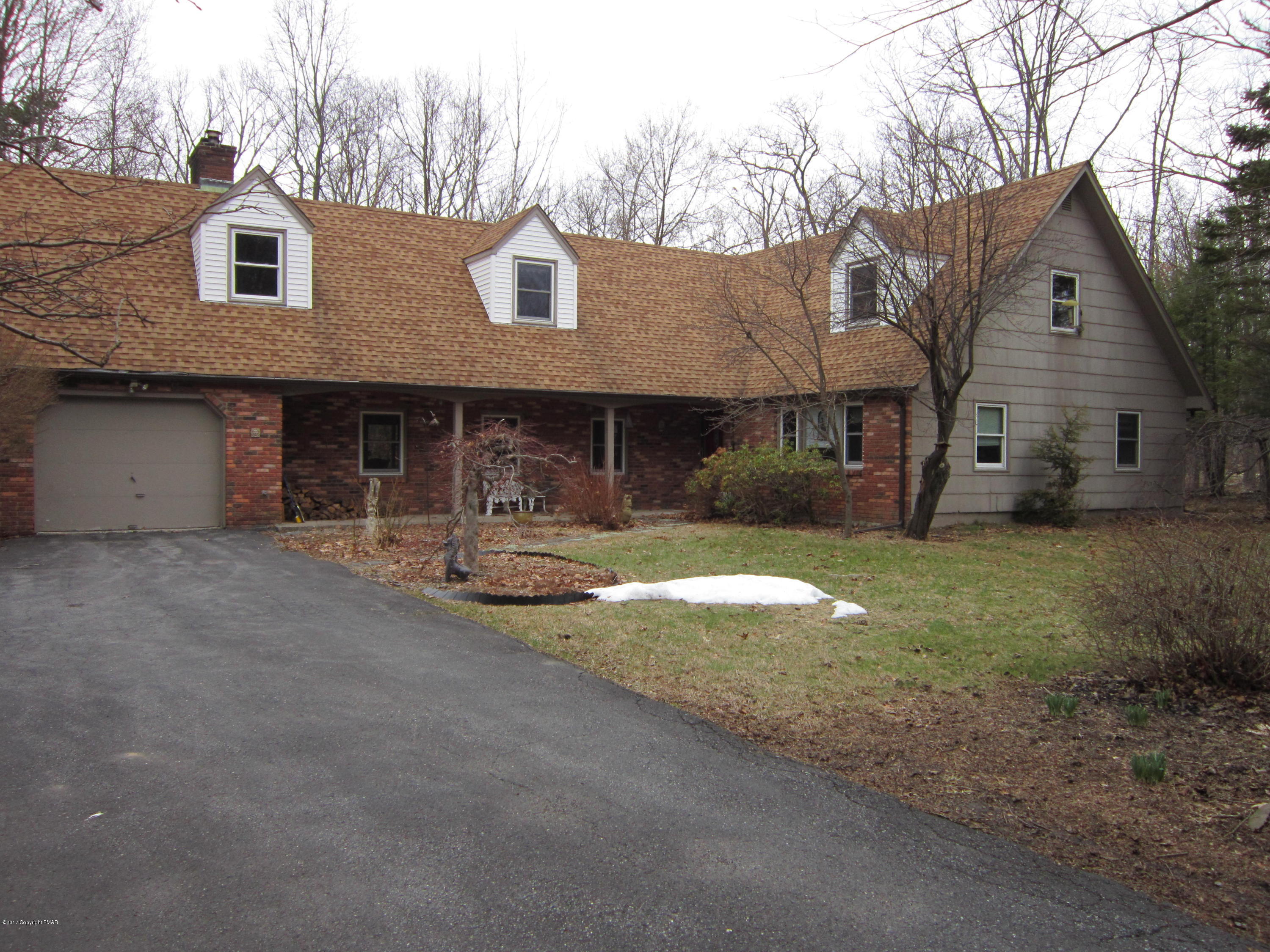 319 Henry's Crossing Road Cresco, PA 18326 - Photo 1 of 29 a front view of a house with garden