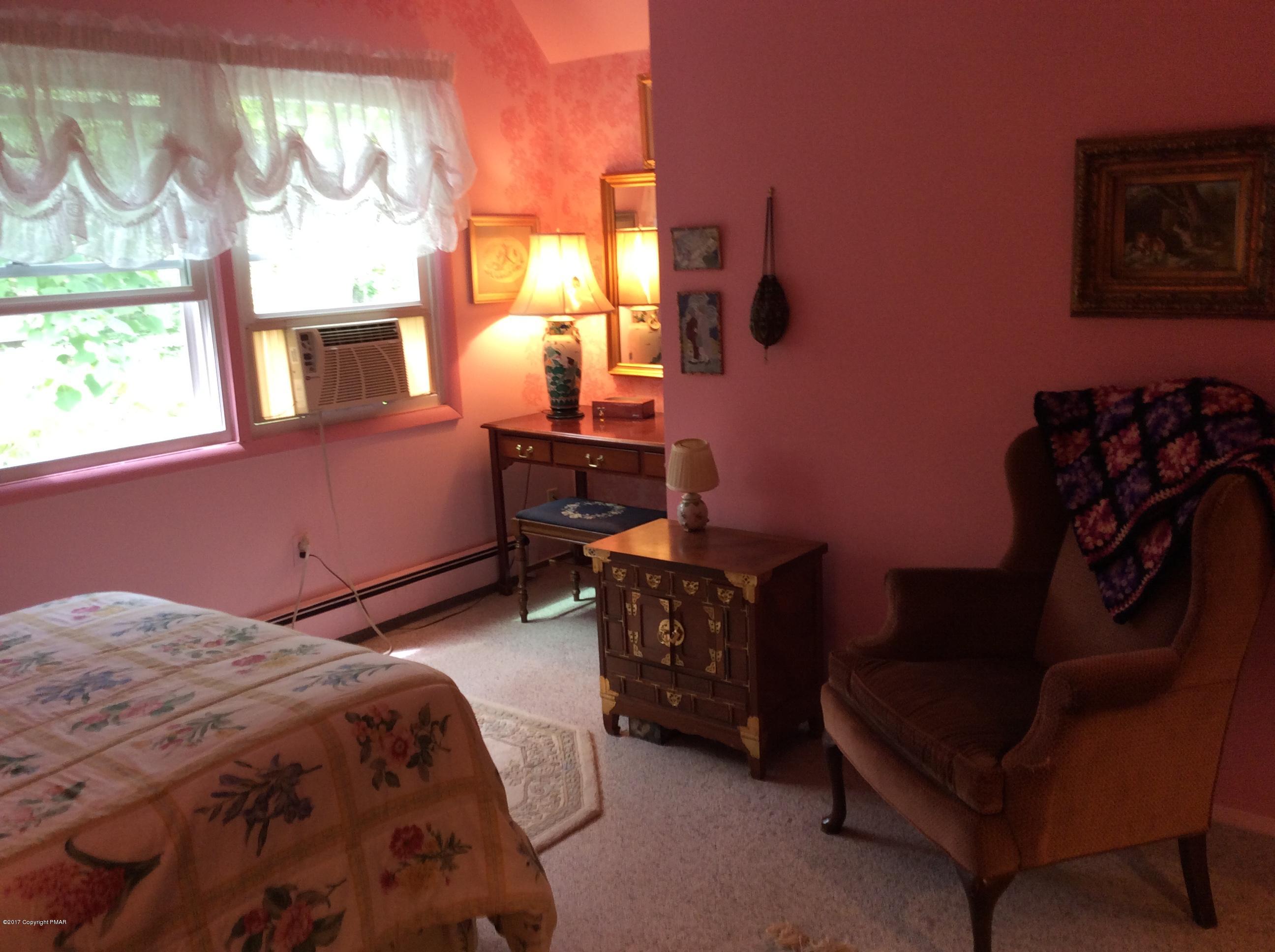 319 Henry's Crossing Road Cresco, PA 18326 - Photo 16 of 29 a bedroom with a bed chair and a window