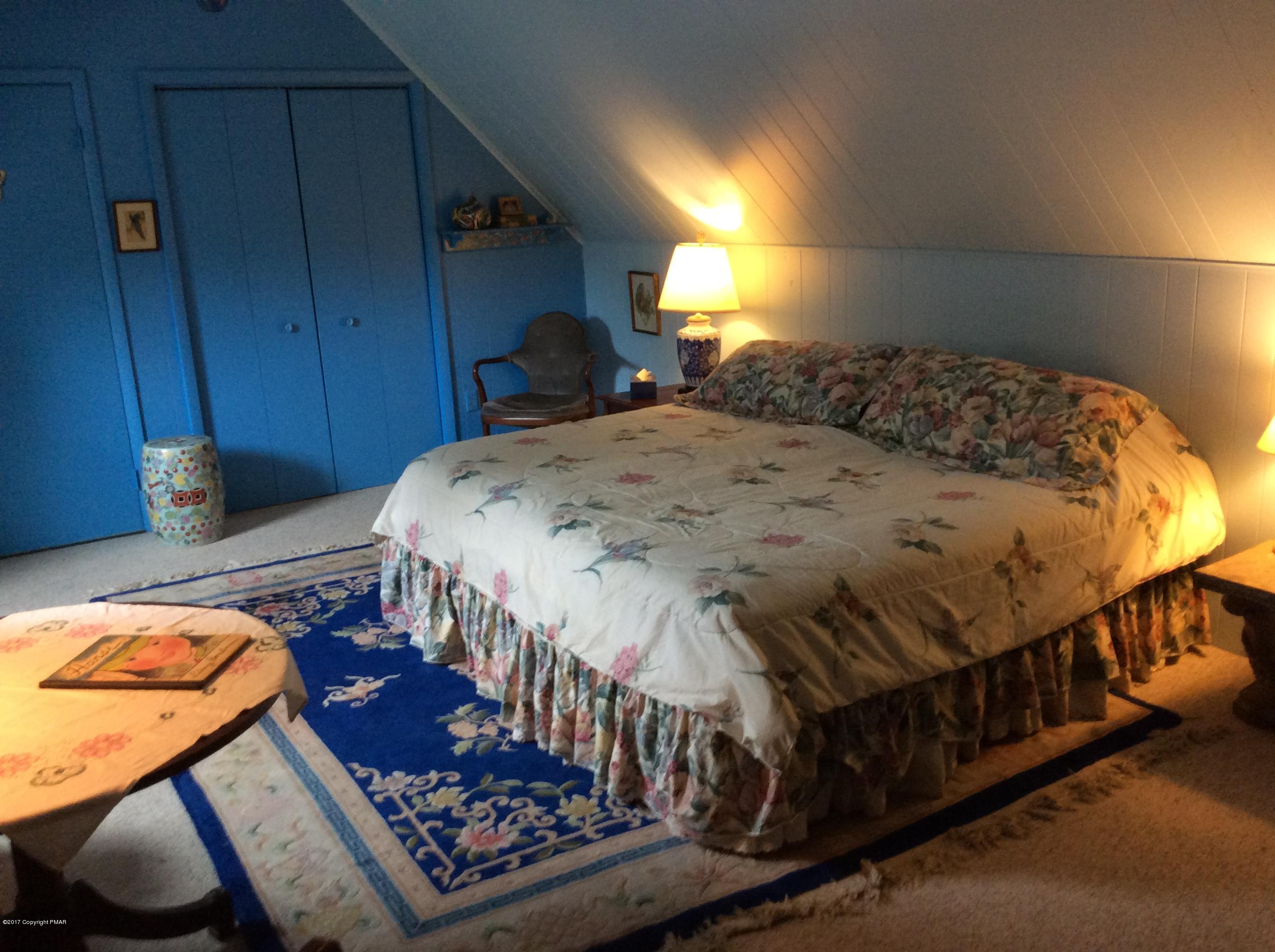 319 Henry's Crossing Road Cresco, PA 18326 - Photo 20 of 29 a bed sitting in a bedroom next to a window