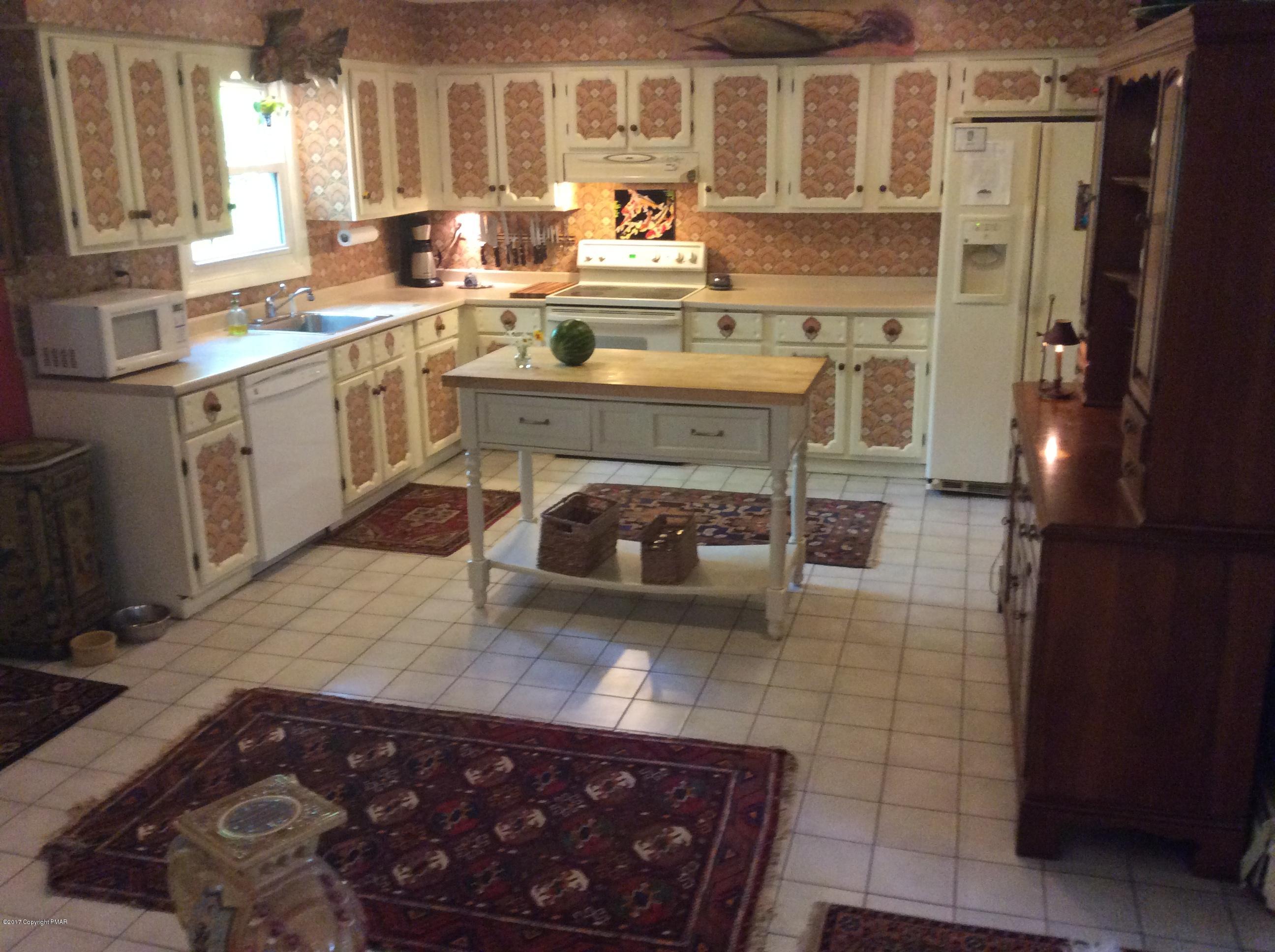319 Henry's Crossing Road Cresco, PA 18326 - Photo 5 of 29 a kitchen with a sink stove and cabinets