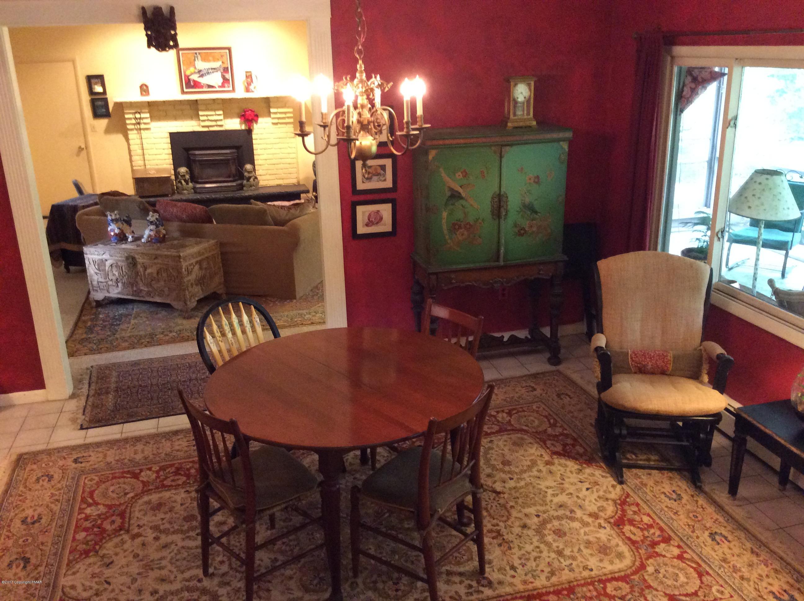 319 Henry's Crossing Road Cresco, PA 18326 - Photo 7 of 29 a living room with furniture a rug and a fireplace