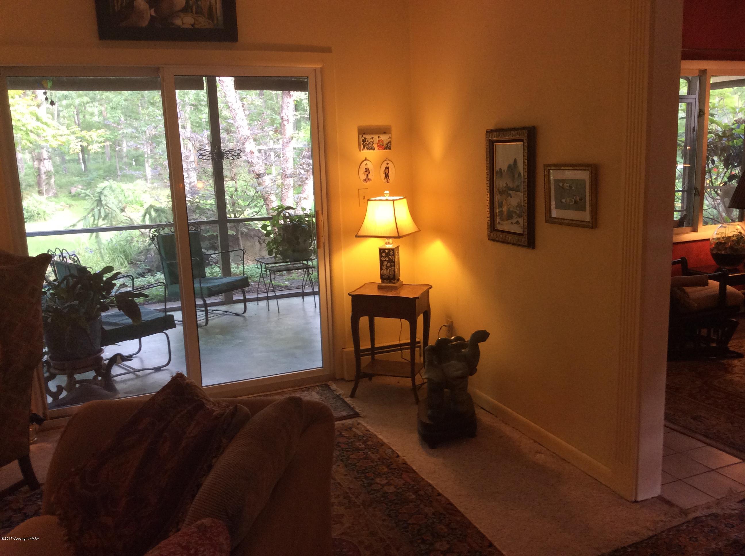 319 Henry's Crossing Road Cresco, PA 18326 - Photo 8 of 29 a living room with furniture and a floor to ceiling window