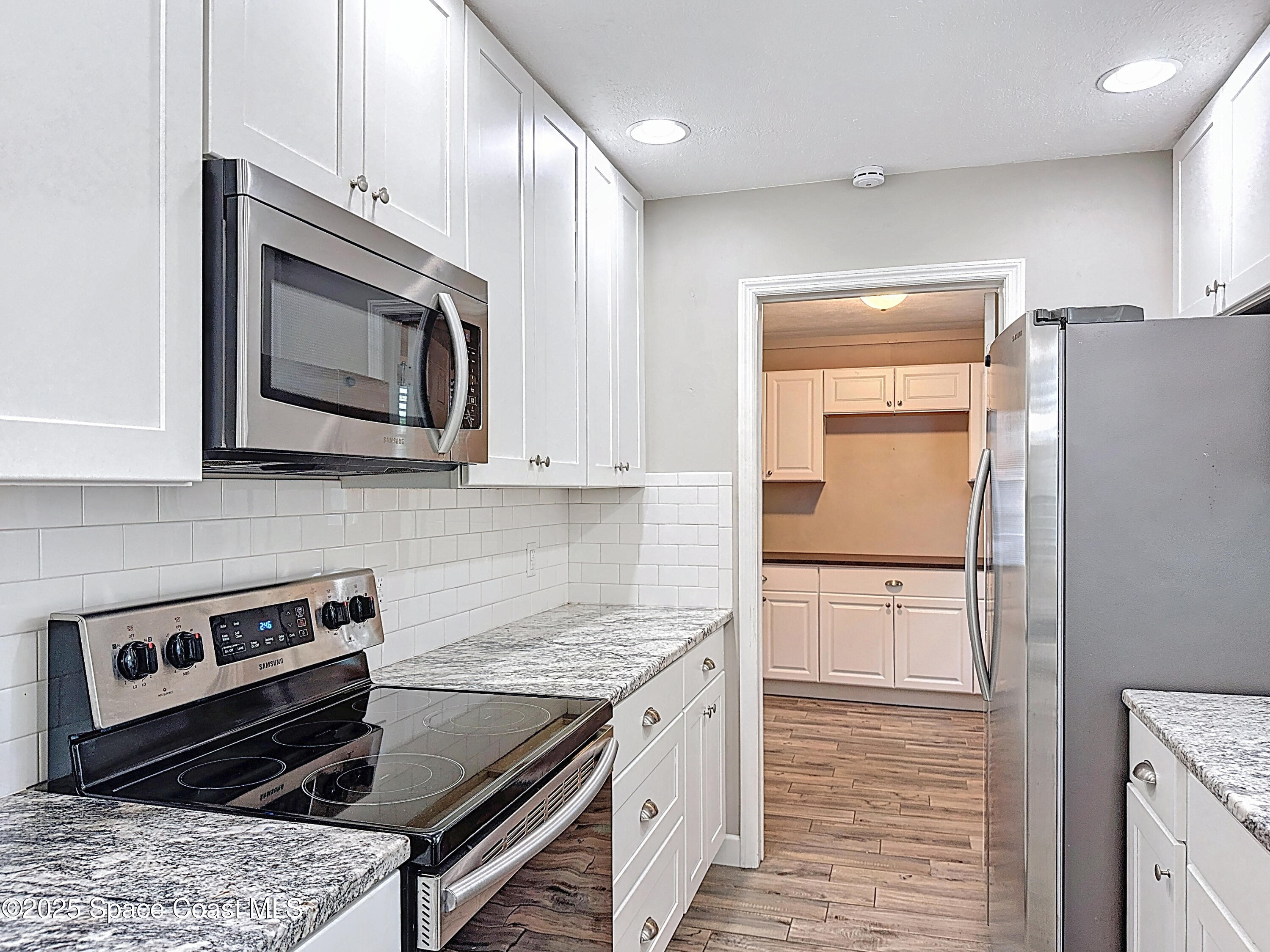 170 Moore Avenue Merritt Island, FL 32952 - Photo 11 of 23 a kitchen with a stove microwave and sink
