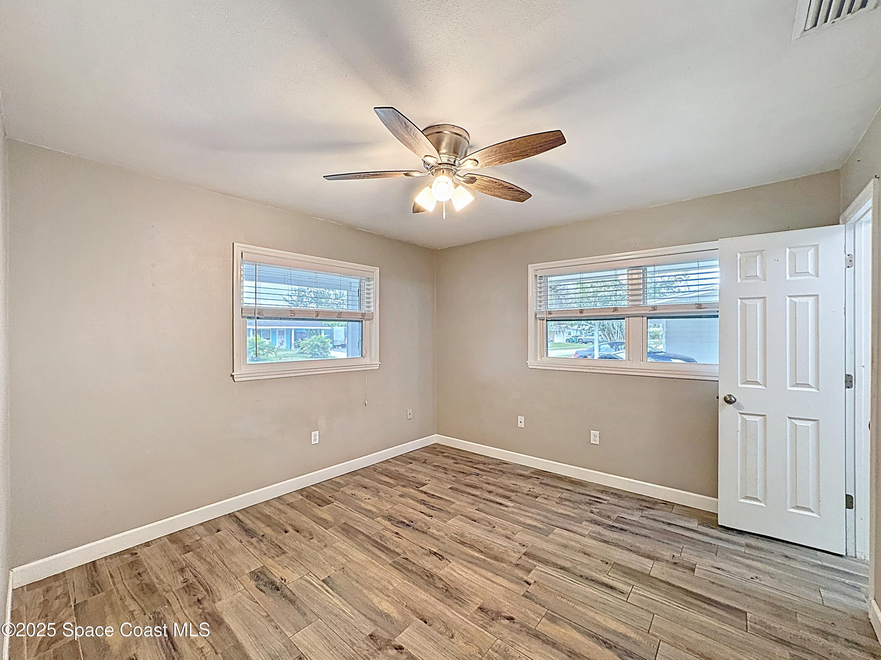 170 Moore Avenue Merritt Island, FL 32952 - Photo 12 of 23 wooden floor in an empty room with a window
