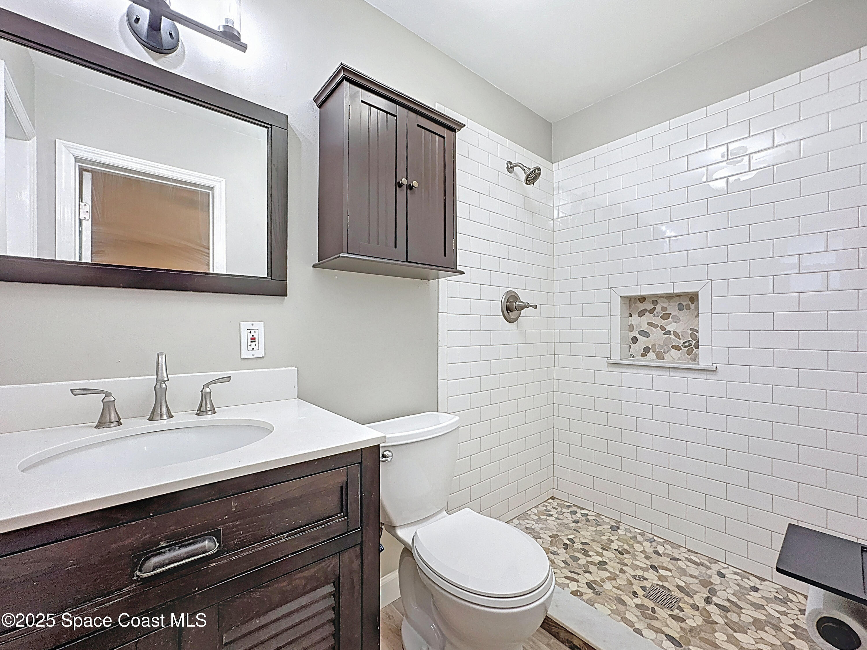 170 Moore Avenue Merritt Island, FL 32952 - Photo 13 of 23 a bathroom with a sink mirror vanity and toilet