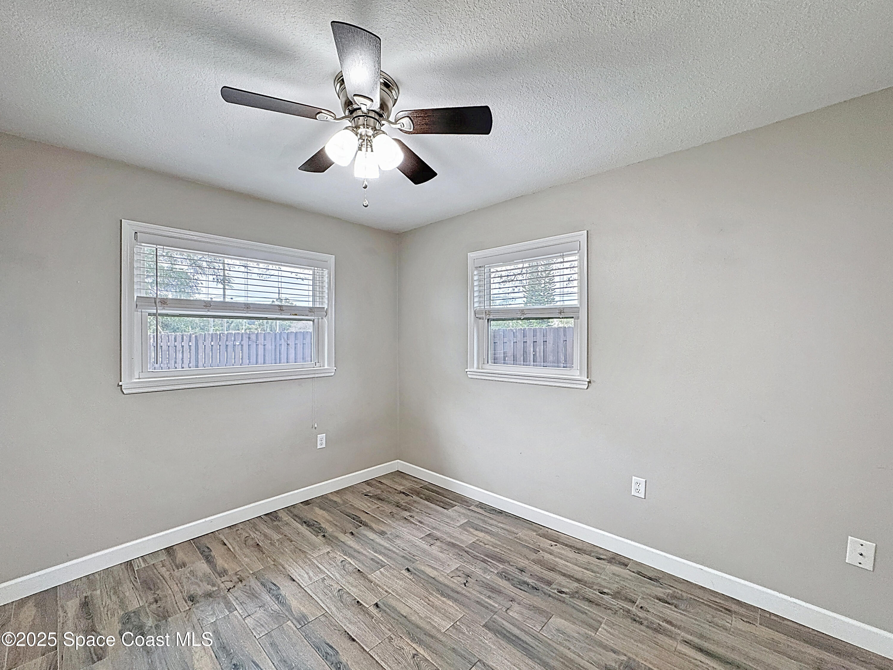 170 Moore Avenue Merritt Island, FL 32952 - Photo 15 of 23 a view of a room with wooden floor and chandelier fan
