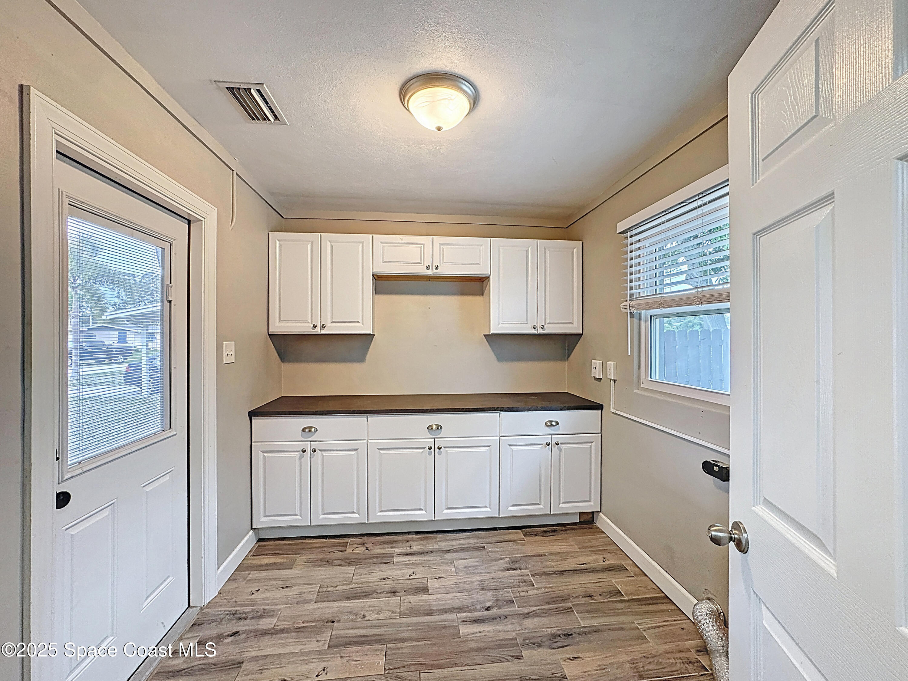 170 Moore Avenue Merritt Island, FL 32952 - Photo 20 of 23 a kitchen with granite countertop white cabinets and refrigerator