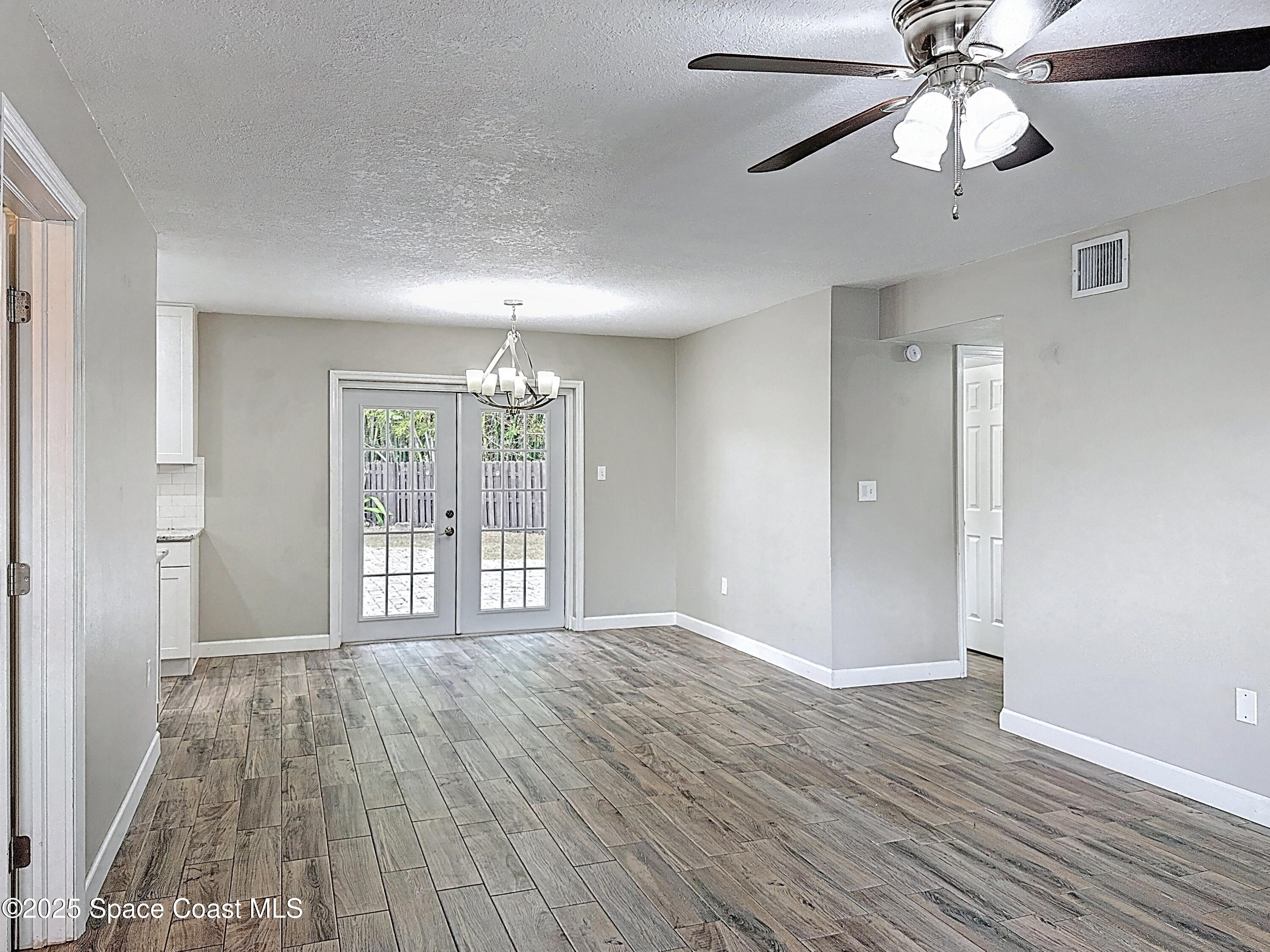 170 Moore Avenue Merritt Island, FL 32952 - Photo 4 of 23 a view of an empty room with wooden floor and a window