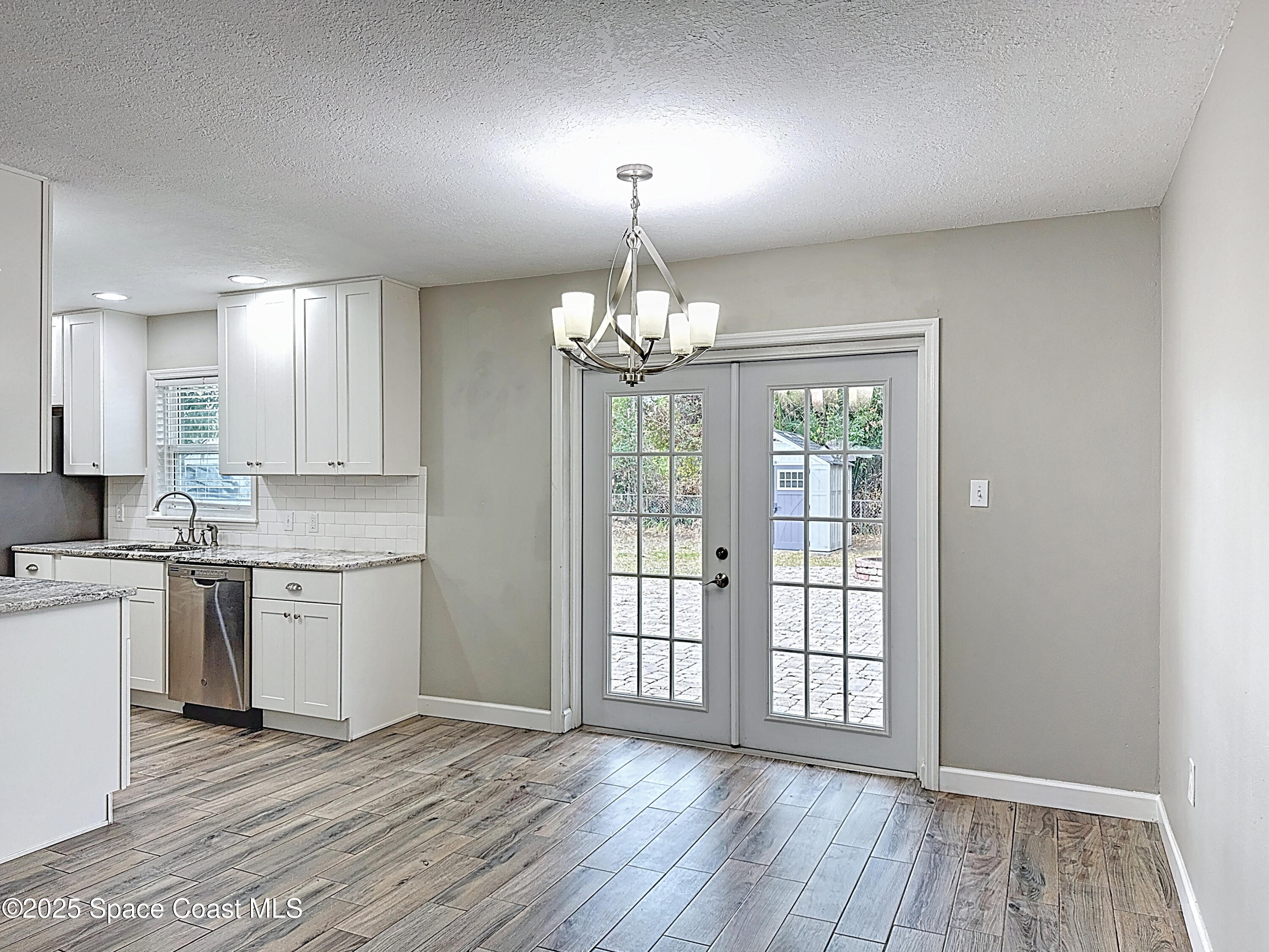 170 Moore Avenue Merritt Island, FL 32952 - Photo 7 of 23 a kitchen that has a lot of white cabinets and wooden floor