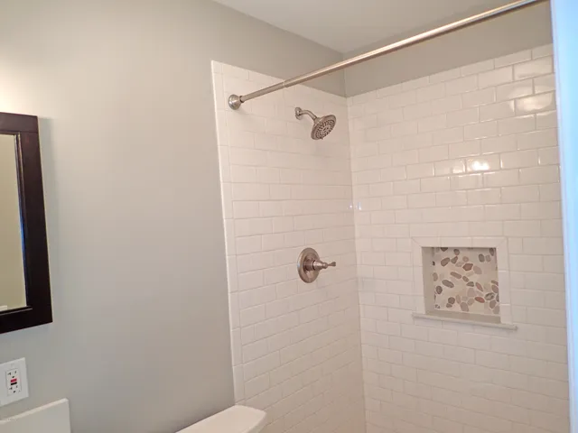 a bathroom with a shower and a toilet