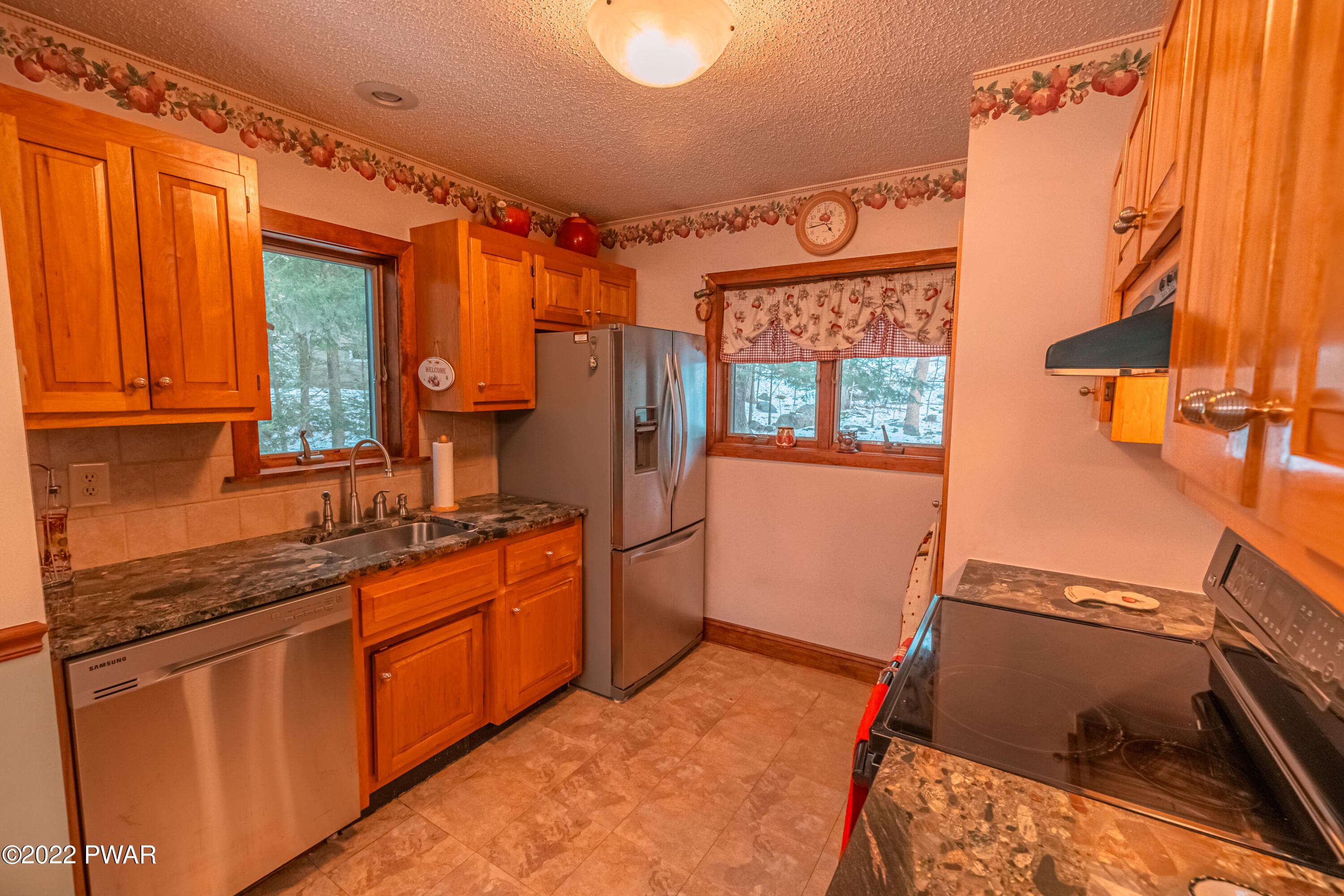 4141 Winchester Way Bushkill, PA 18324 - Photo 17 of 75 a kitchen with stainless steel appliances granite countertop a refrigerator and a stove top oven