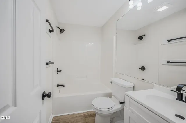 a white toilet sitting next to a bathroom sink