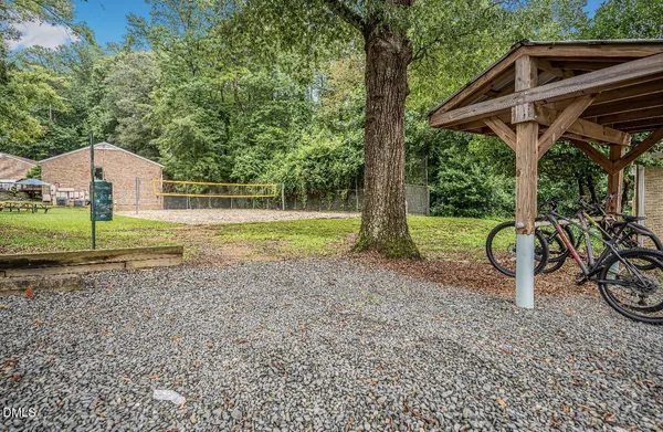 a view of a backyard with table and chairs under an umbrella