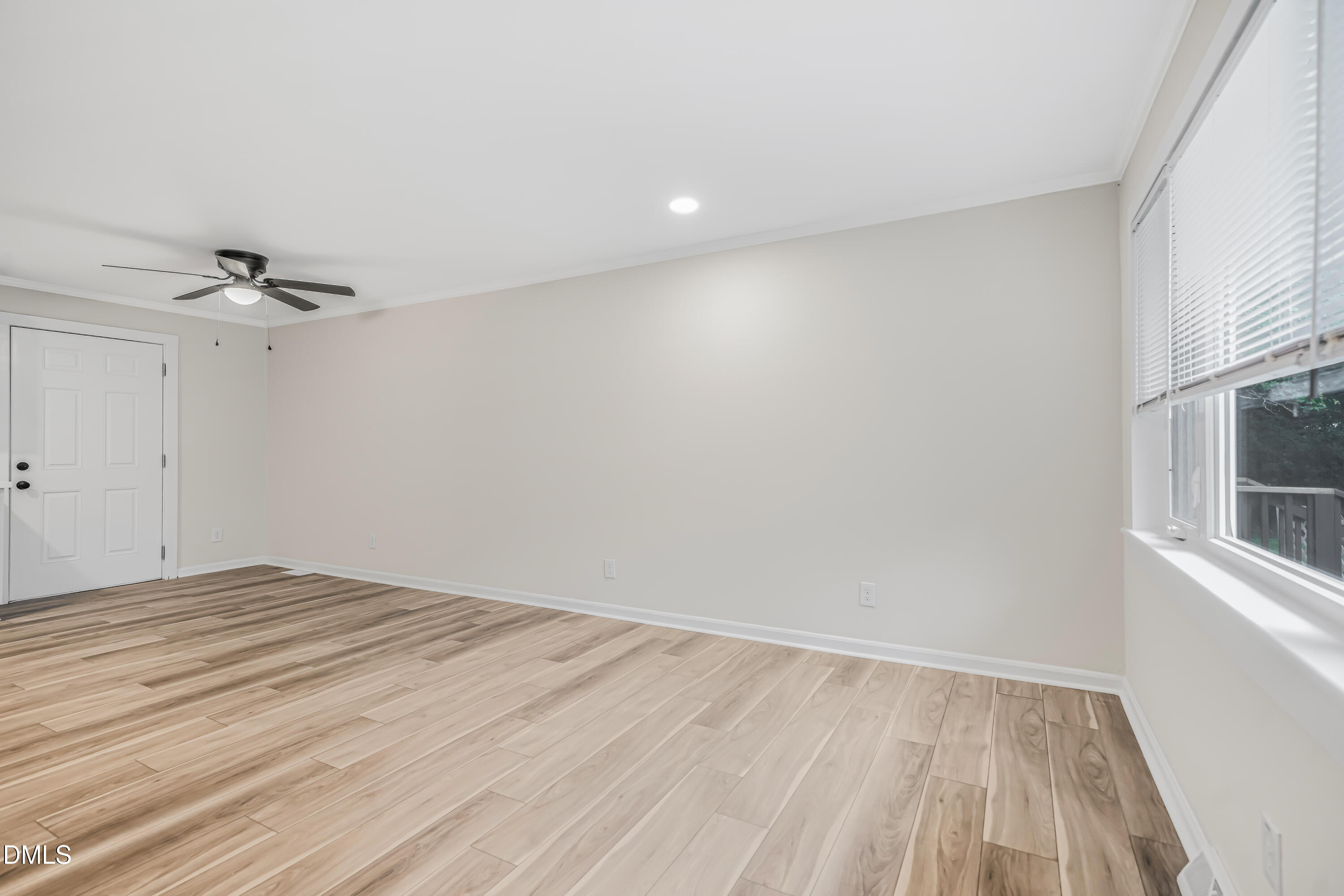 201 Howell Street, Unit 300A Chapel Hill, NC 27514 - Photo 6 of 15 a view of empty room with wooden floor and fan