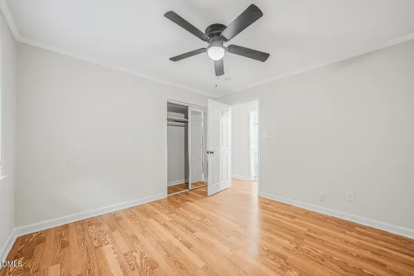 a view of empty room with wooden floor