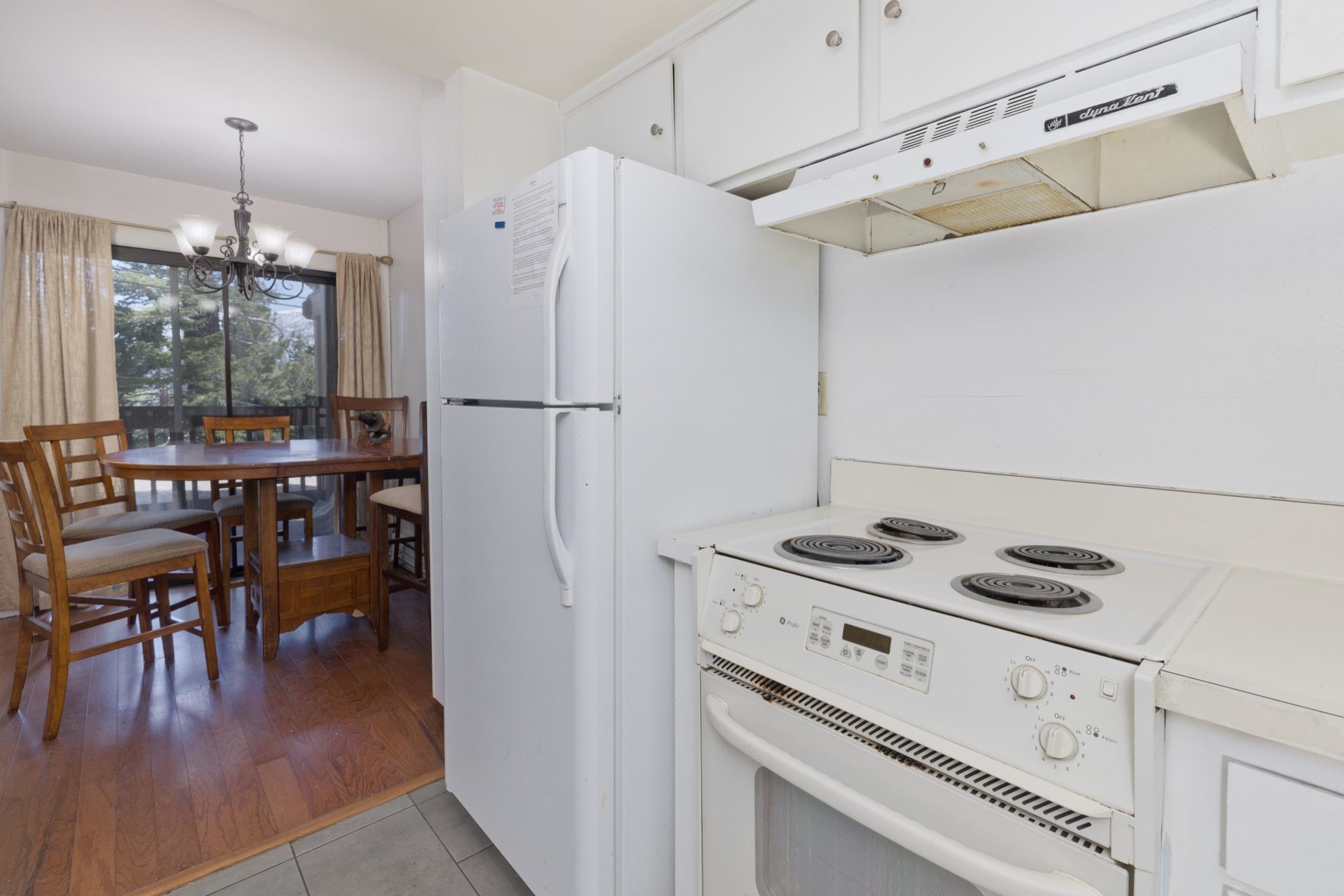 25 Lee Road, Unit 103 Mammoth Lakes, CA 93546 - Photo 15 of 29 a kitchen with appliances cabinets and wooden floor