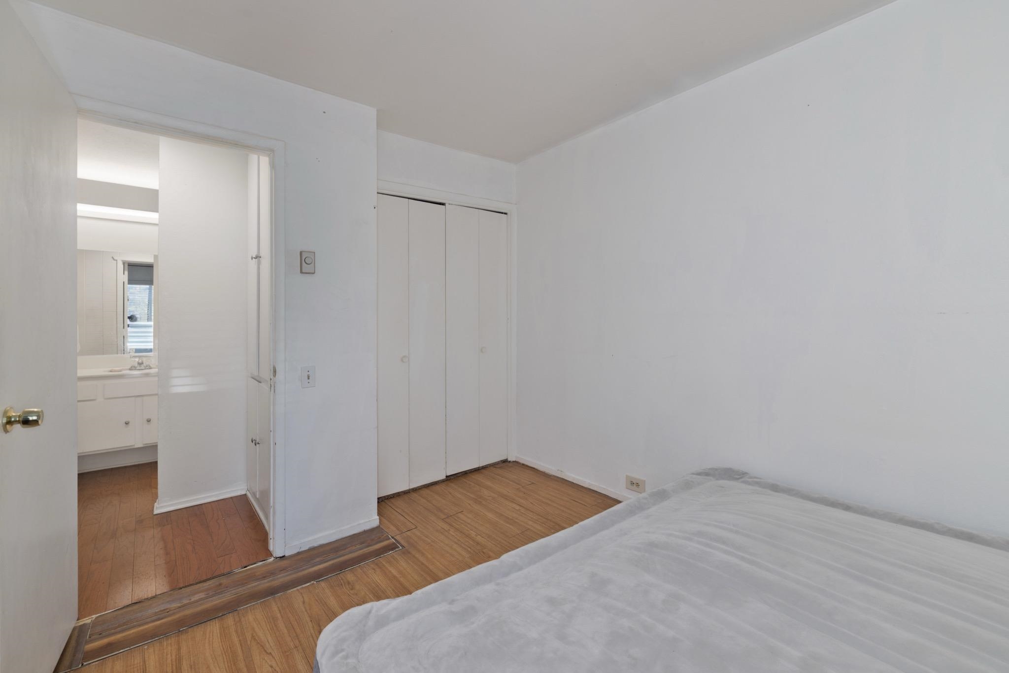 25 Lee Road, Unit 103 Mammoth Lakes, CA 93546 - Photo 16 of 29 an empty room with wooden floor and mirror