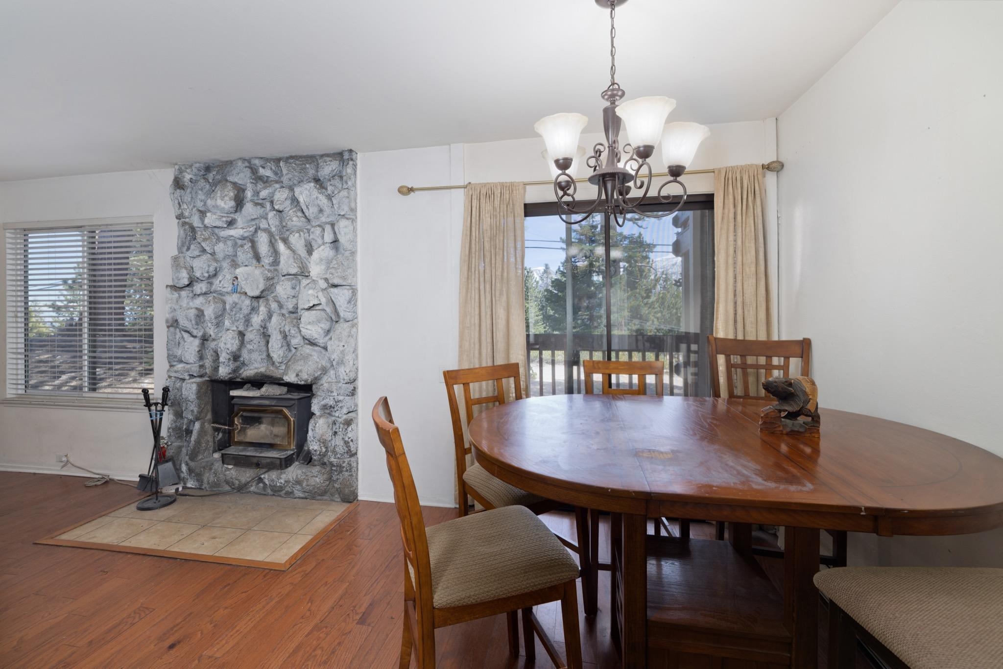 25 Lee Road, Unit 103 Mammoth Lakes, CA 93546 - Photo 4 of 29 a dining room with furniture a chandelier and wooden floor