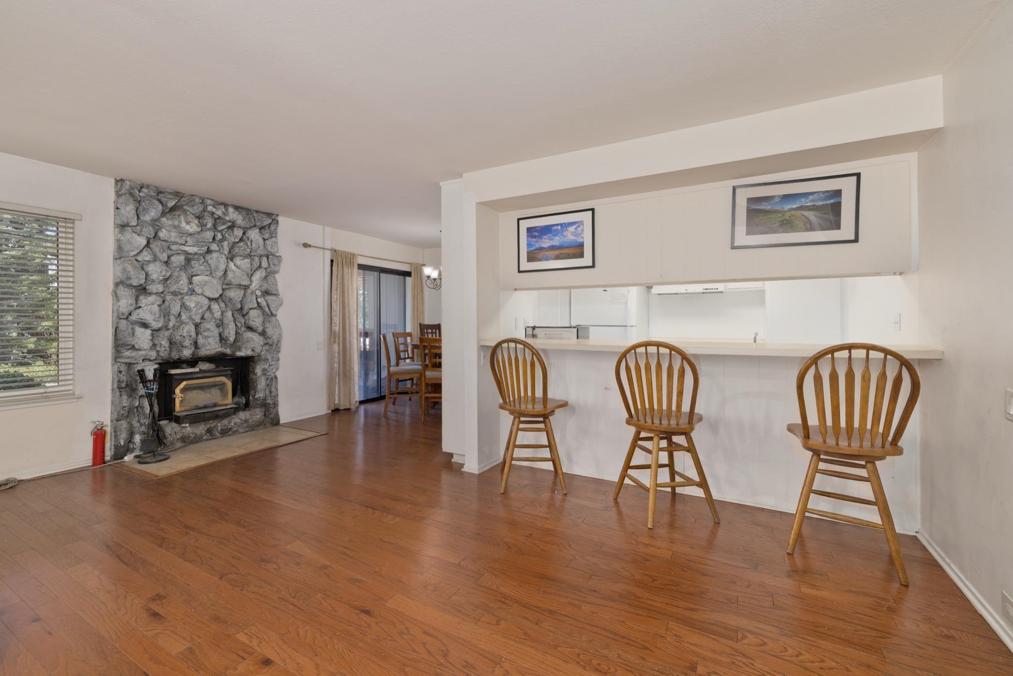 25 Lee Road, Unit 103 Mammoth Lakes, CA 93546 - Photo 8 of 29 a view of a livingroom with furniture a fireplace wooden floor and windows