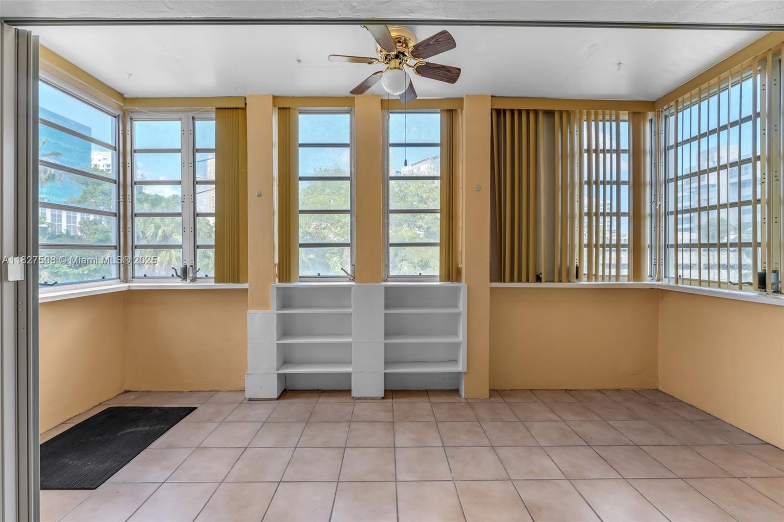 9159 Southwest 77th Avenue, Unit 314 Miami, FL 33156 - Photo 11 of 22 a view of room with window and a ceiling fan