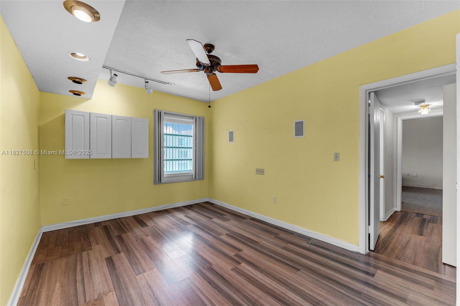 9159 Southwest 77th Avenue, Unit 314 Miami, FL 33156 - Photo 12 of 22 a view of a room with wooden floor and ceiling fan