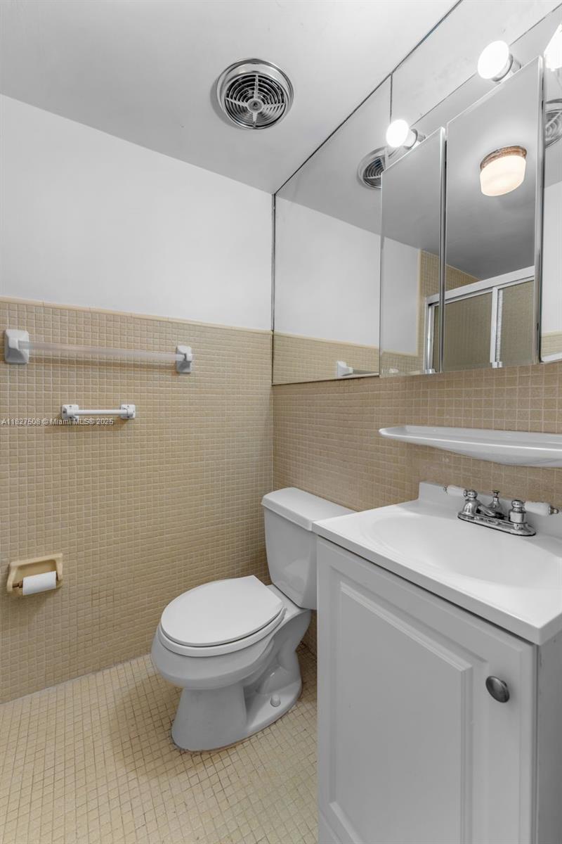 9159 Southwest 77th Avenue, Unit 314 Miami, FL 33156 - Photo 14 of 22 a bathroom with a sink a toilet and mirror