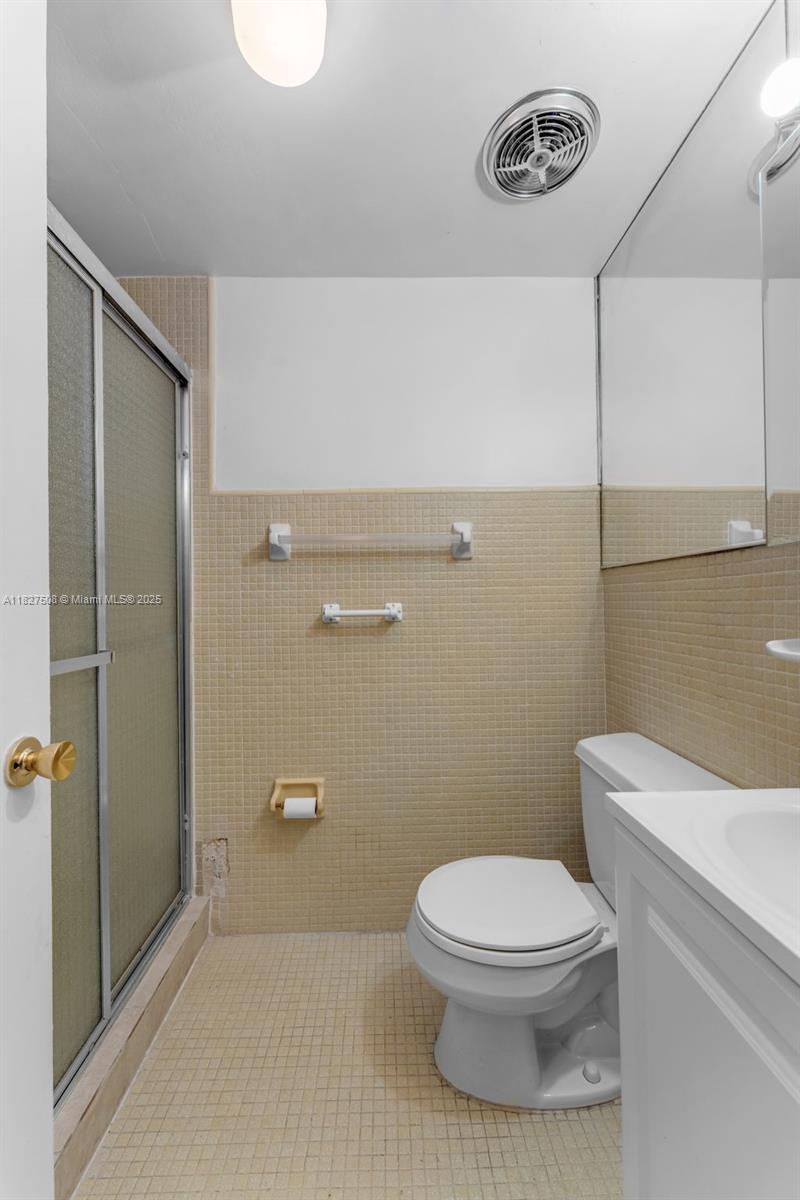 9159 Southwest 77th Avenue, Unit 314 Miami, FL 33156 - Photo 15 of 22 a bathroom with a toilet and a shower