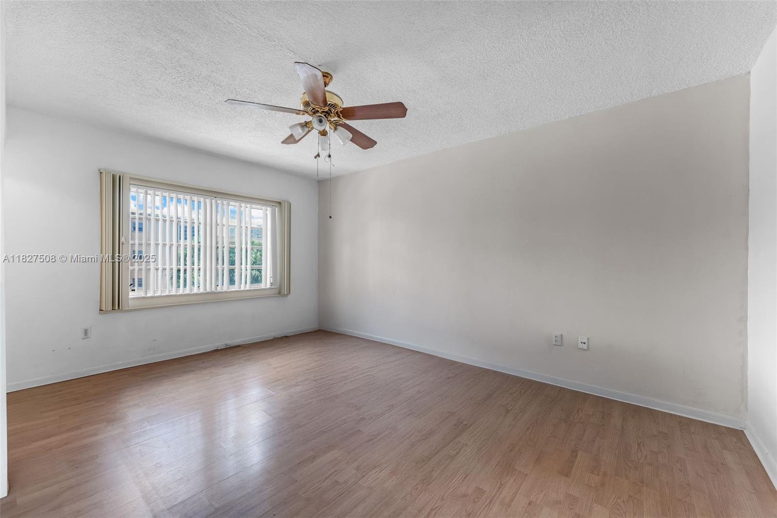 9159 Southwest 77th Avenue, Unit 314 Miami, FL 33156 - Photo 16 of 22 wooden floor in an empty room with a window
