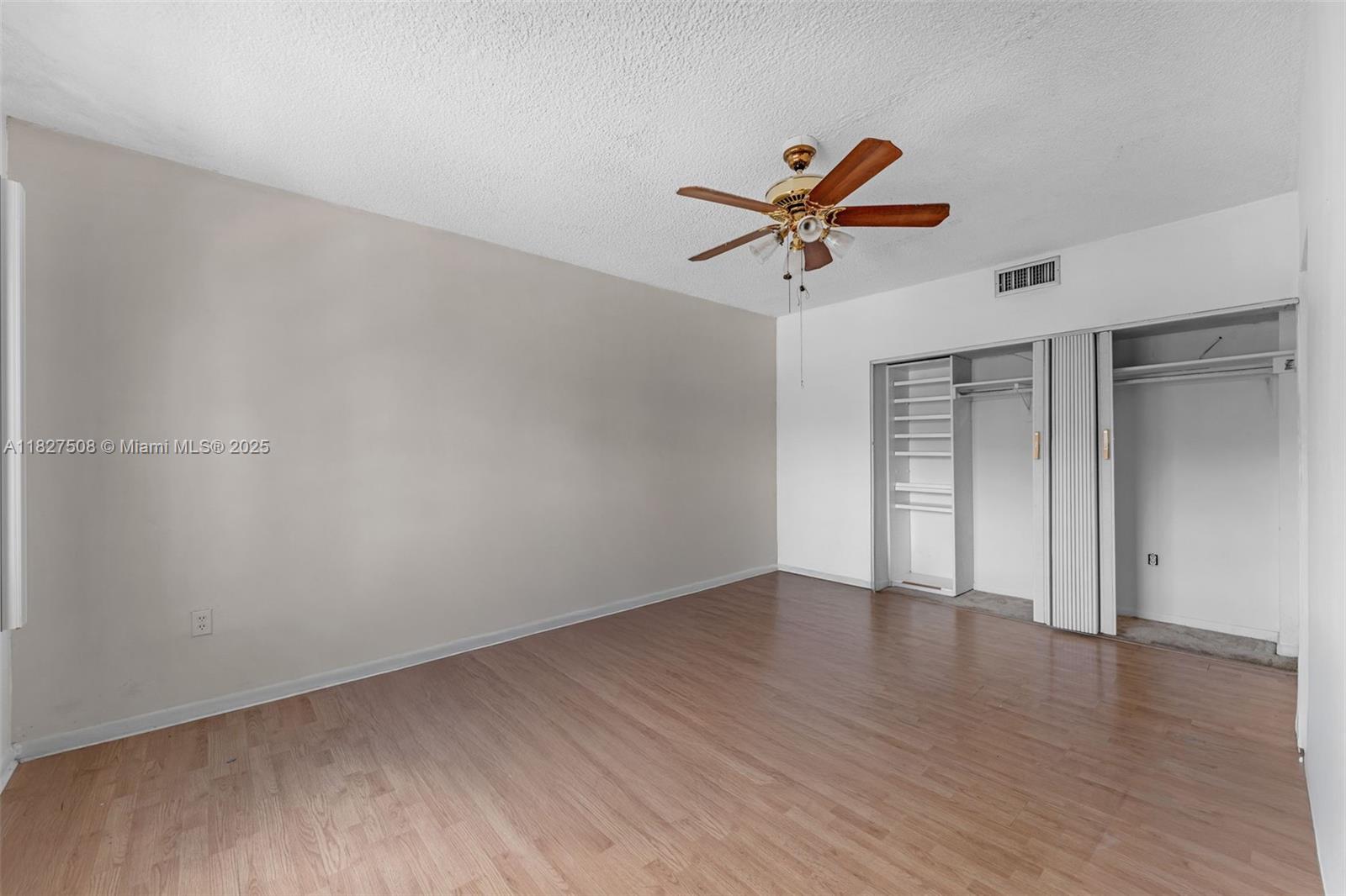 9159 Southwest 77th Avenue, Unit 314 Miami, FL 33156 - Photo 17 of 22 a view of room with hardwood floor and a ceiling fan