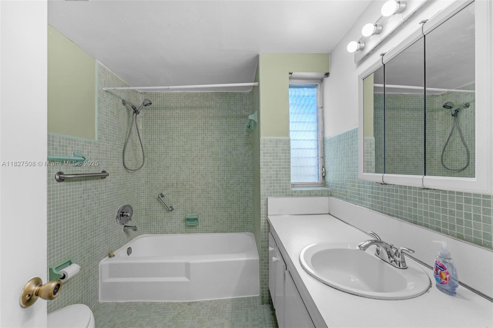 9159 Southwest 77th Avenue, Unit 314 Miami, FL 33156 - Photo 19 of 22 a bathroom with a tub sink and mirror