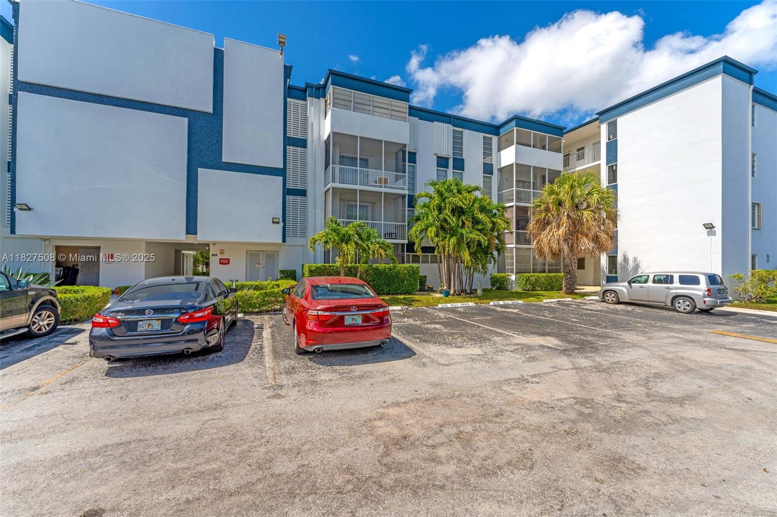 9159 Southwest 77th Avenue, Unit 314 Miami, FL 33156 - Photo 2 of 22 a car parked in front of yellow house