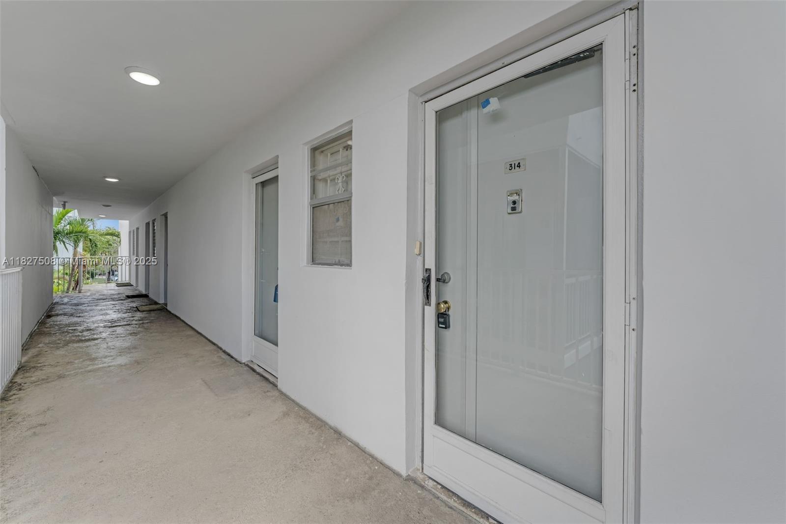 9159 Southwest 77th Avenue, Unit 314 Miami, FL 33156 - Photo 4 of 22 a view of a hallway with wooden shelves