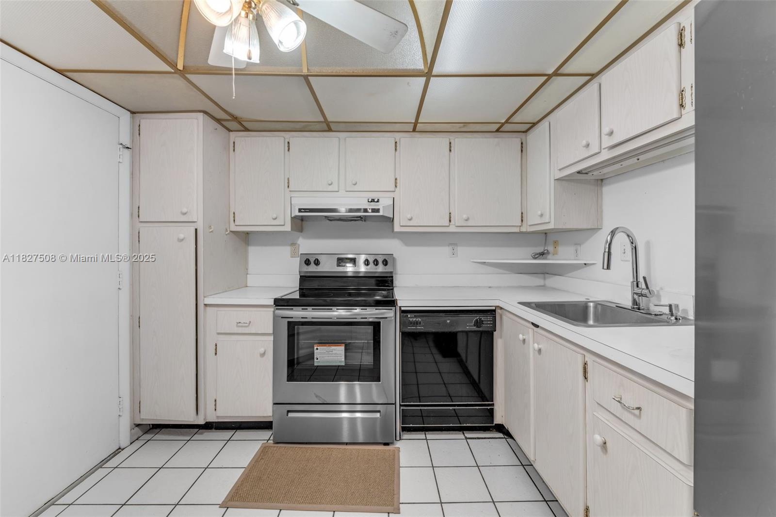 9159 Southwest 77th Avenue, Unit 314 Miami, FL 33156 - Photo 5 of 22 a kitchen with stainless steel appliances granite countertop a sink stove and refrigerator