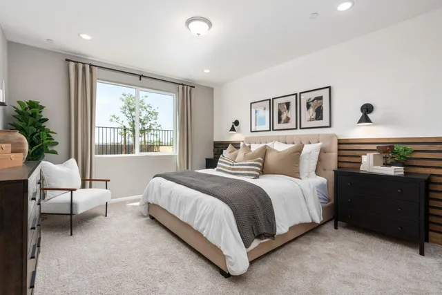 a spacious bedroom with a bed and a window