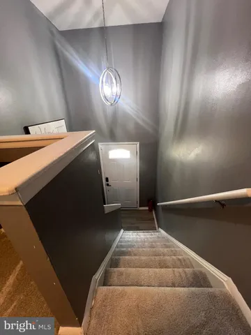 a room with a chandelier and a wooden floor