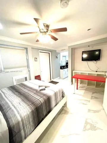 a bedroom with a bed and a flat screen tv